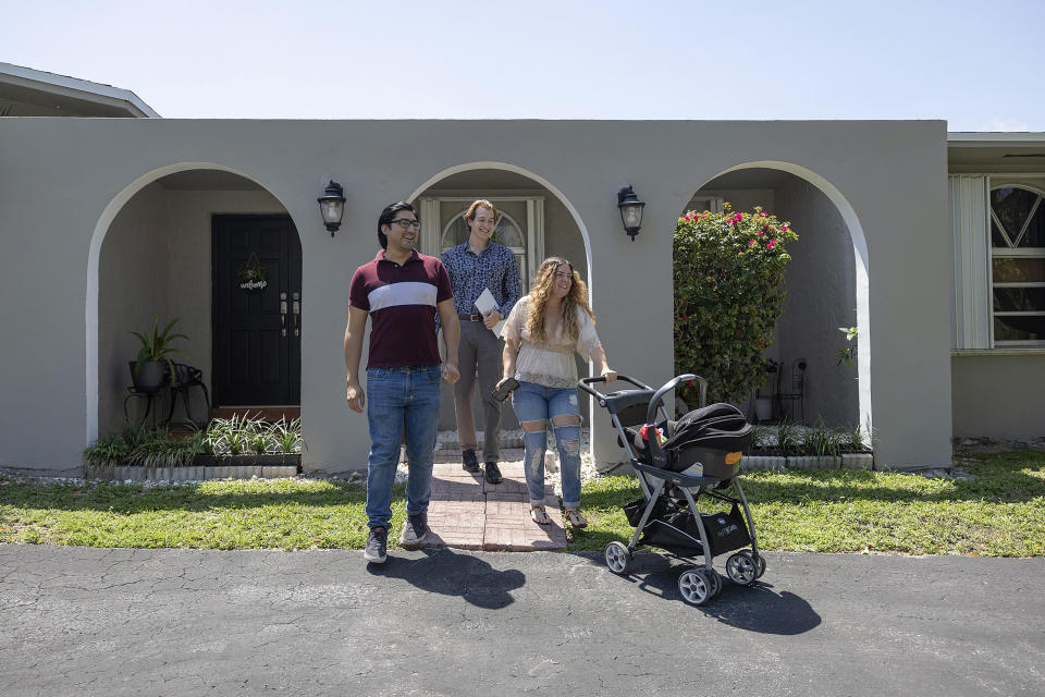 CUTLER BAY, FLORIDA - APRIL 20: Ryan Ratliff (C), Real Estate Sales Manager, Re/Max Advance Realty, shows homes for sale by Ryan Paredes (L) and Ariadna Paredes on April 20, 2023 in Cutler Bay, Florida give.  According to a report from the National Association of Realtors, existing home sales in March fell 2.4% to an annual rate of 4.44 million.  In addition, sales decreased by 22.0% from a year ago. (Photo by Joe Raedle/Getty Images)